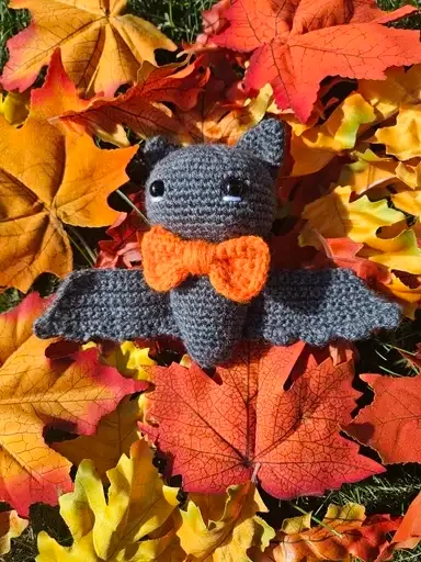 Bat on leaves with bow tie